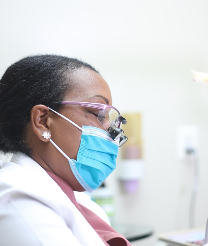 Doctor Hightower wearing a face mask while treating a patient