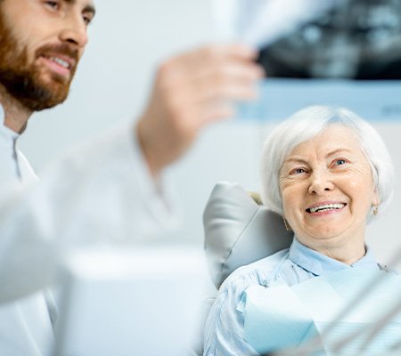 Older woman smiling with new dental implants