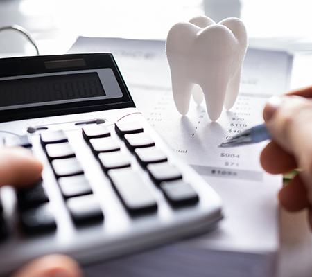 A patient using a calculator to learn the cost of dental emergencies